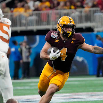 Arizona State running back Cam Skattebo (4) runs against Texas defensive back Jelani McDonald (25) during the third quarter of the Chick-fil-A Peach Bowl in Atlanta on Jan. 1, 2025.