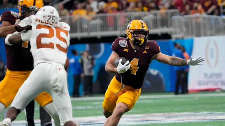 Arizona State running back Cam Skattebo (4) runs against Texas defensive back Jelani McDonald (25) during the third quarter of the Chick-fil-A Peach Bowl in Atlanta on Jan. 1, 2025. Arizona State running back Cam Skattebo (4) runs against Texas defensive back Jelani McDonald (25) during the third quarter of the Chick-fil-A Peach Bowl in Atlanta on Jan. 1, 2025.