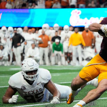 Arizona State running back Cam Skattebo (4) escapes a tackle by Texas defensive lineman Alfred Collins (95) during the fourth quarter in the Chick-fil-A Peach Bowl in Atlanta on Wednesday, Jan. 1, 2025.