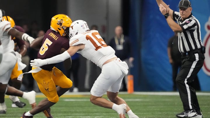 Arizona State wide receiver Melquan Stovall (5) is tackled by Texas defensive back Michael Taaffe (16) after a catch during the fourth quarter in the Chick-fil-A Peach Bowl in Atlanta on Jan. 1, 2025. The play was reviewed for targeting but was not called. Arizona State wide receiver Melquan Stovall (5) is tackled by Texas defensive back Michael Taaffe (16) after a catch during the fourth quarter in the Chick-fil-A Peach Bowl in Atlanta on Jan. 1, 2025. The play was reviewed for targeting but was not called.