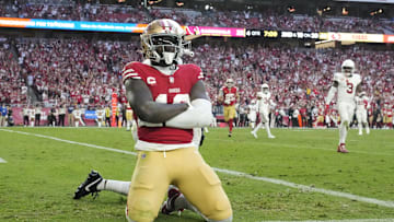 San Francisco 49ers wide receiver Deebo Samuel (19) poses after a touchdown catch against the Arizona Cardinals during the fourth quarter at State Farm Stadium.