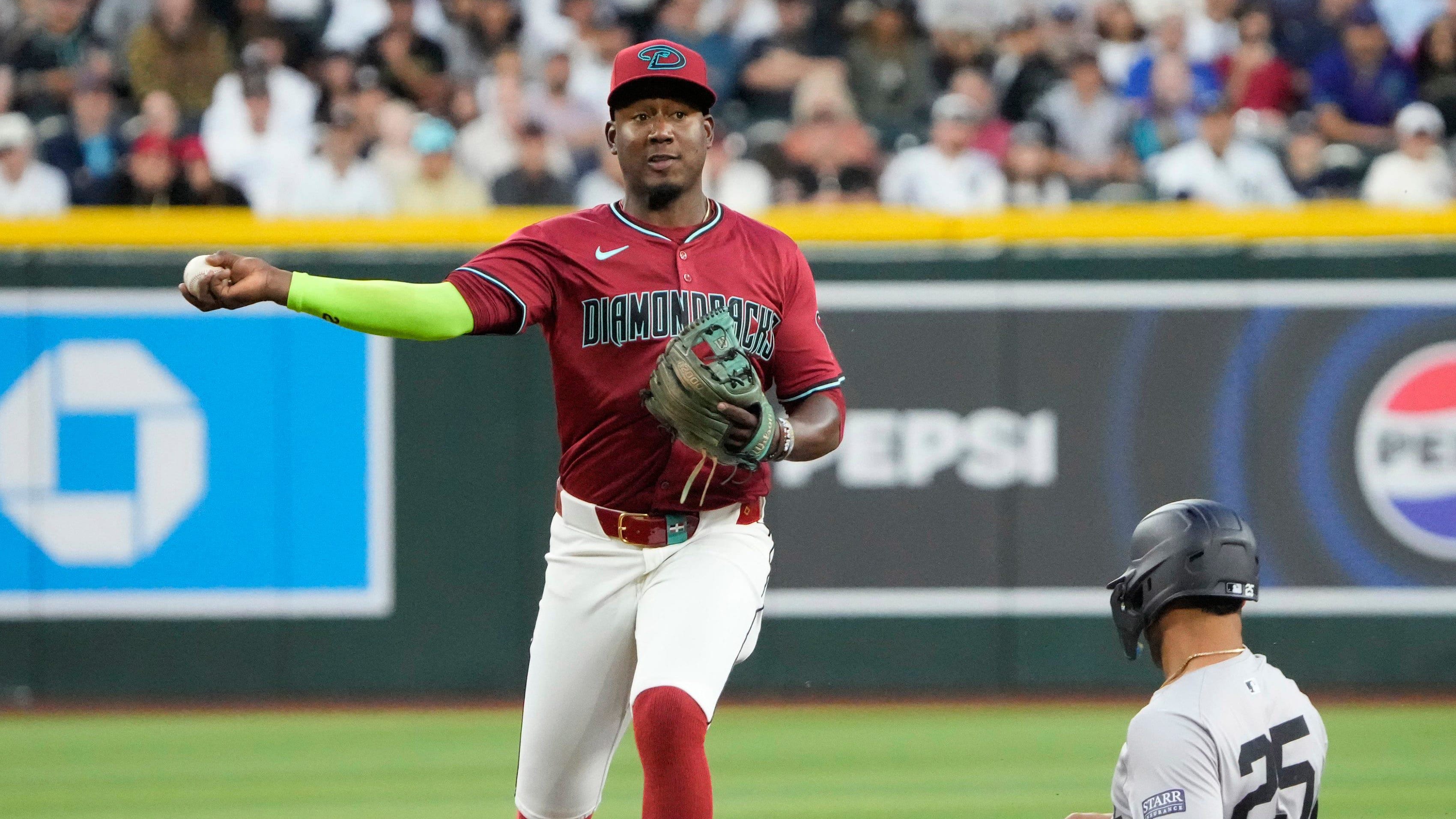 Arizona Diamondbacks shortstop Geraldo Perdomo throws to first after forcing out New York Yankees infielder Gleyber Torres.