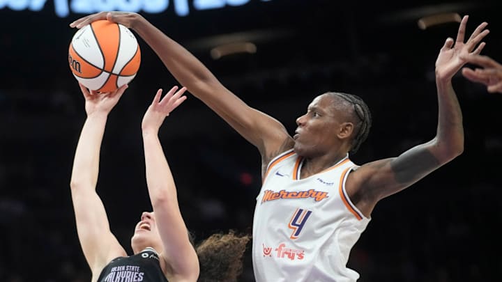 Phoenix Mercury forward Natasha Mack (4) blocks a shot by Golden State Valkyries guard Carla Leite (0) during pre-season action at PHX Arena May 11, 2025. Phoenix Mercury forward Natasha Mack (4) blocks a shot by Golden State Valkyries guard Carla Leite (0) during pre-season action at PHX Arena May 11, 2025.