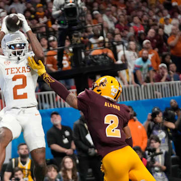 Texas wide receiver Matthew Golden (2) catches a pass while defended by Arizona State defensive back Xavion Alford.