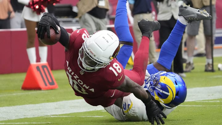 Arizona Cardinals wide receiver Marvin Harrison Jr. (18) reaches the ball over for a touchdown against Los Angeles Rams safety Kamren Curl (3) during the first quarter at State Farm Stadium on Sept. 15, 2024.