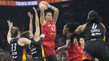 Atlanta Dream center Brittney Griner (42) passes the ball while defended by Phoenix Mercury forward Kathryn Westbeld (24) and guard Sami Whitcomb (33) during the first quarter at PHX Arena Jul 23, 2025.