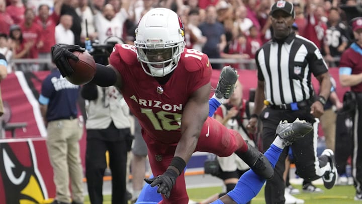 Arizona Cardinals wide receiver Marvin Harrison Jr. (18) reaches the ball over for a touchdown against Los Angeles Rams safety Kamren Curl (3)during the first quarter at State Farm Stadium on Sept. 15, 2024.