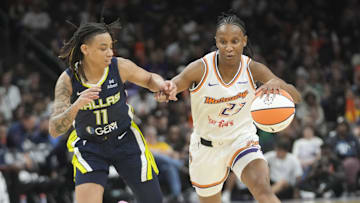 Phoenix Mercury guard Kiana Williams (23) is defended by Dallas Wings guard JJ Quinerly (11) during the third quarter at PHX Arena on July 7, 2025.