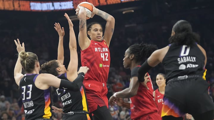 Atlanta Dream center Brittney Griner (42) passes the ball while defended by Phoenix Mercury forward Kathryn Westbeld (24) and guard Sami Whitcomb (33) during the first quarter at PHX Arena Jul 23, 2025.