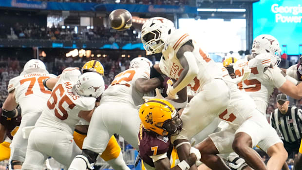 Arizona State defensive back Shamari Simmons forces a fumble by Texas running back Quintrevion Wisner.