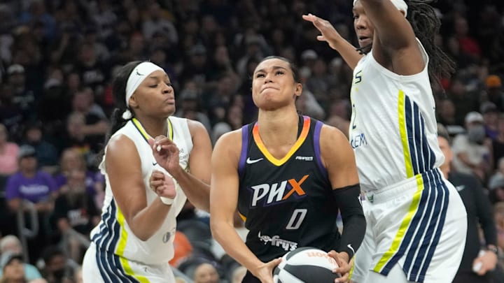 Phoenix Mercury forward Satou Sabally (0) splits Dallas Wings forwards NaLyssa Smith (1) and Myisha Hines-Allen (2) during the first quarter in Phoenix, at PHX Arena on June 11, 2025. Phoenix Mercury forward Satou Sabally (0) splits Dallas Wings forwards NaLyssa Smith (1) and Myisha Hines-Allen (2) during the first quarter in Phoenix, at PHX Arena on June 11, 2025.