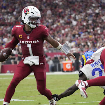 Arizona Cardinals quarterback Kyler Murray (1) breaks a tackle by Los Angeles Rams cornerback Tre'Davious White (27) during the fourth quarter at State Farm Stadium.