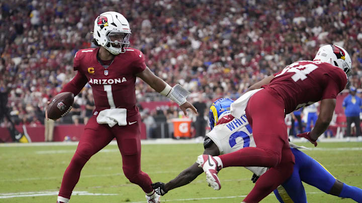 Arizona Cardinals quarterback Kyler Murray (1) breaks a tackle by Los Angeles Rams cornerback Tre'Davious White (27) during the fourth quarter at State Farm Stadium.