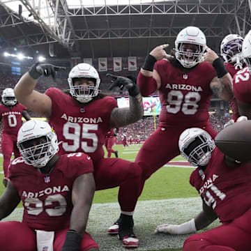 Arizona Cardinals defensive end L.J. Collier (91) celebrates his fumble recovery with teammates against the Los Angeles Rams during the fourth quarter at State Farm Stadium.