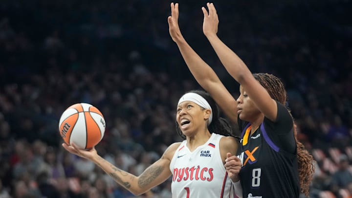 Washington Mystics guard Sug Sutton (1) is defended by Phoenix Mercury guard Monique Akoa Makani (8) during the first quarter at PHX Arena on May 25, 2025.