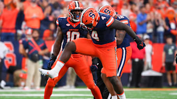 Aug 31, 2024; Syracuse, New York, USA; Syracuse Orange defensive lineman Dion Wilson Jr. (4) celebrates with teammates after a defensive play against the Ohio Bobcats during the first half at the JMA Wireless Dome. Mandatory Credit: Rich Barnes-Imagn Images