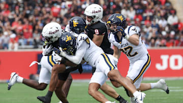 Nov 1, 2025; Houston, Texas, USA; Houston Cougars running back DJ Butler (25) is knocked out of bounds by West Virginia Mountaineers safety Israel Boyce (7)  in the first half at TDECU Stadium. Mandatory Credit: Thomas Shea-Imagn Images