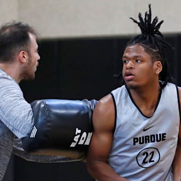 Purdue director of player development Sasha Stefanovic defends Gicarri Harris during practice, 