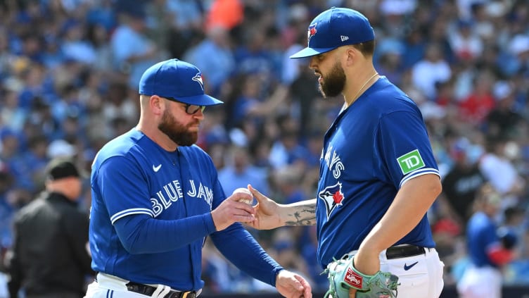 Jul 29, 2023; Toronto, Ontario, CAN; Toronto Blue Jays manager John Schneider (14) relieves pitcher