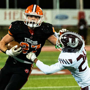 Byron’s Caden Considine (37) pushes off defense during the IHSA 3A football state championship game against Tolono Unity on Nov. 28, 2025, at Illinois State University in Normal.