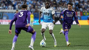 Jul 5, 2025; Charlotte, North Carolina, USA; Charlotte FC defender Adilson Malanda (29) tries to elude Orlando City defender Rafael Santos (3) during the second half at Bank of America Stadium. Mandatory Credit: Jim Dedmon-Imagn Images