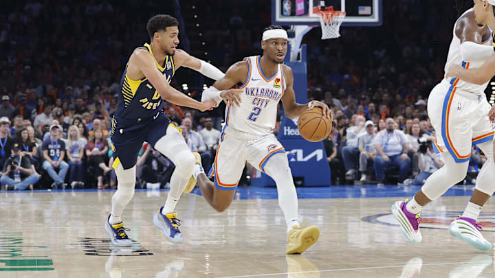 Oklahoma City Thunder guard Shai Gilgeous-Alexander drives to the basket beside Indiana Pacers guard Tyrese Haliburton. Oklahoma City Thunder guard Shai Gilgeous-Alexander drives to the basket beside Indiana Pacers guard Tyrese Haliburton.