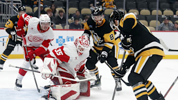 Oct 1, 2024; Pittsburgh, Pennsylvania, USA;  Detroit Red Wings goaltender Ville Husso (35) defends the net against Pittsburgh Penguins left wing Michael Bunting (8) and right wing Bryan Rust (right) during the third period at PPG Paints Arena. Detroit won 2-1. Mandatory Credit: Charles LeClaire-Imagn Images