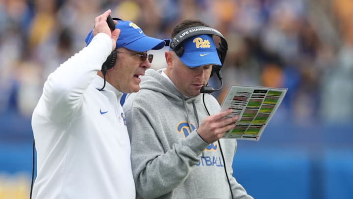 Nov 16, 2024; Pittsburgh, Pennsylvania, USA; Pittsburgh Panthers head coach Pat Narduzzi (left) and offensive coordinator Cade Bell (right) talk on the field against the Clemson Tigers during the fourth quarter at Acrisure Stadium. Mandatory Credit: Charles LeClaire-Imagn Images Nov 16, 2024; Pittsburgh, Pennsylvania, USA; Pittsburgh Panthers head coach Pat Narduzzi (left) and offensive coordinator Cade Bell (right) talk on the field against the Clemson Tigers during the fourth quarter at Acrisure Stadium. Mandatory Credit: Charles LeClaire-Imagn Images