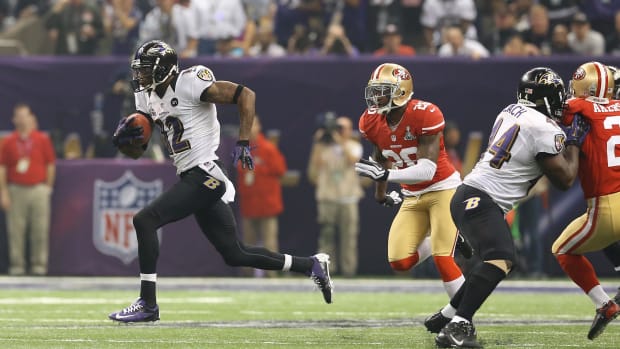 Baltimore Ravens receiver Jacoby Jones (12) scores on a kick return against the San Francisco 49ers in Super Bowl XLVII