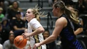 Army's Reese Ericson drives to the net ahead of  Emmanuel College's Angelina Giordano during Monday's game on November 7, 2022.