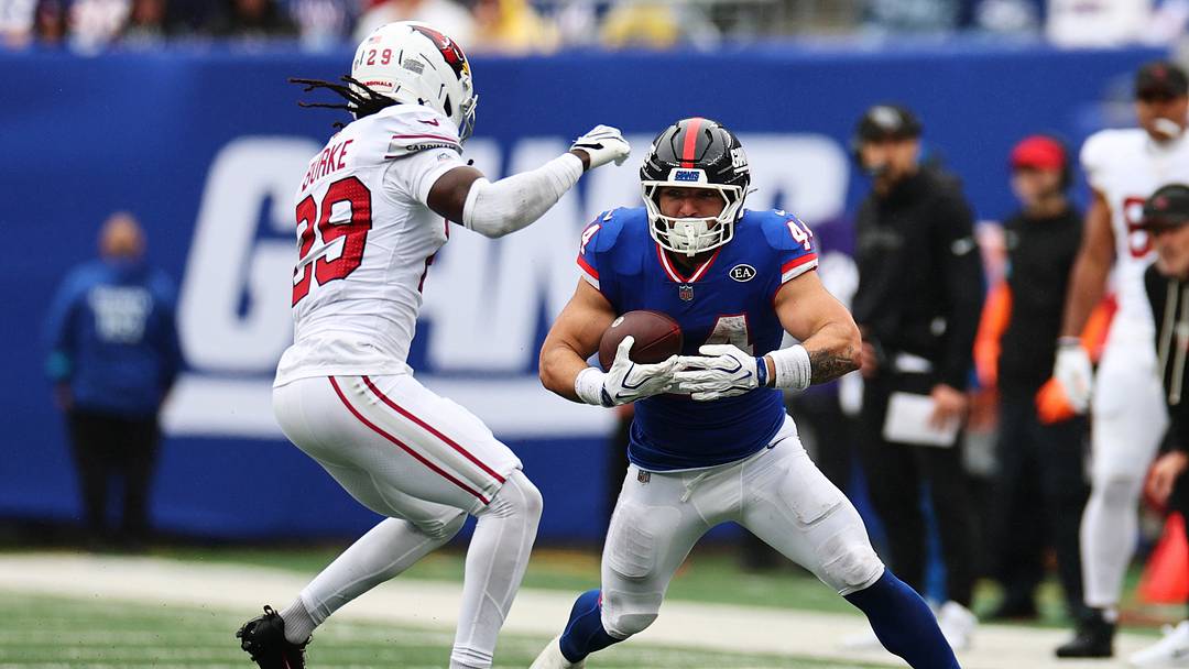 Oct 4, 2026; East Rutherford, New Jersey, USA;  New York Giants running back Cam Skattebo (44) runs the ball against Arizona Cardinals cornerback Denzel Burke (29) during the second quarter at MetLife Stadium.   