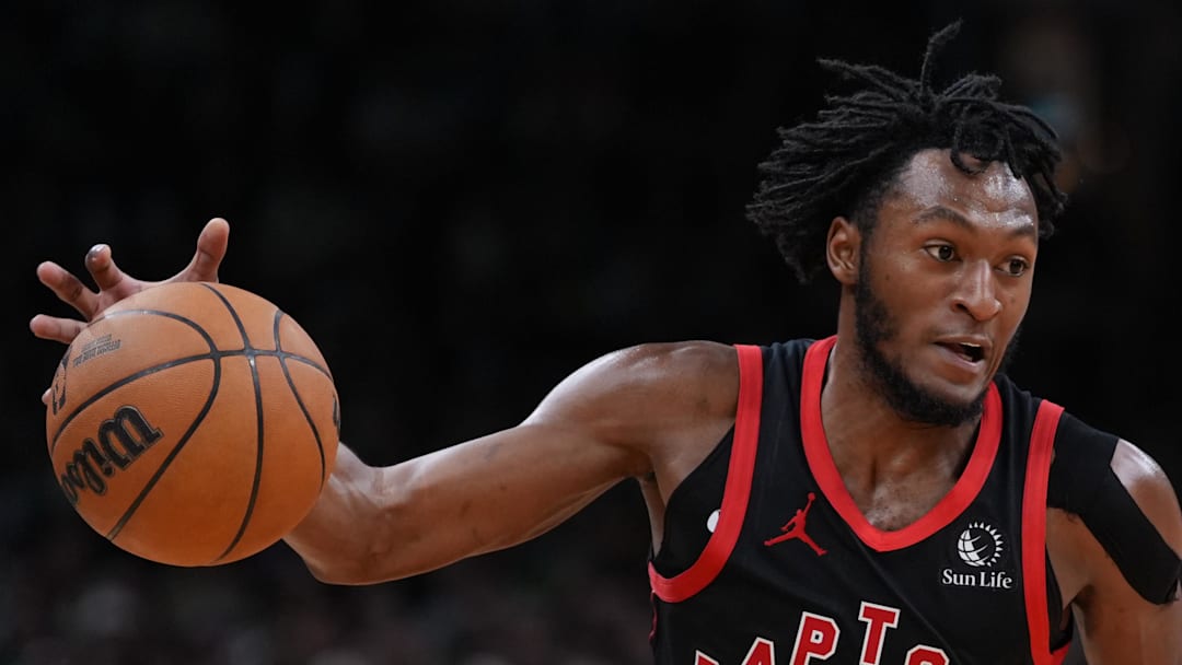 Toronto Raptors guard Immanuel Quickley drives the ball against Boston Celtics center Luka Garza.
