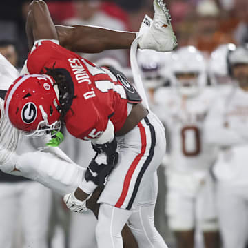 Georgia Bulldogs defensive back Demello Jones tackles Texas Longhorns wide receiver Ryan Wingo in the first half at Sanford Stadium.