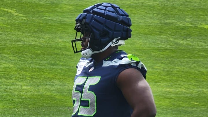 Seahawks rookie tackle Mike Jerrell listens to instructions from coach Scott Huff during OTAs at the VMAC.