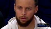 Curry looks on in disbelief from the bench after a three-pointer by Randle.