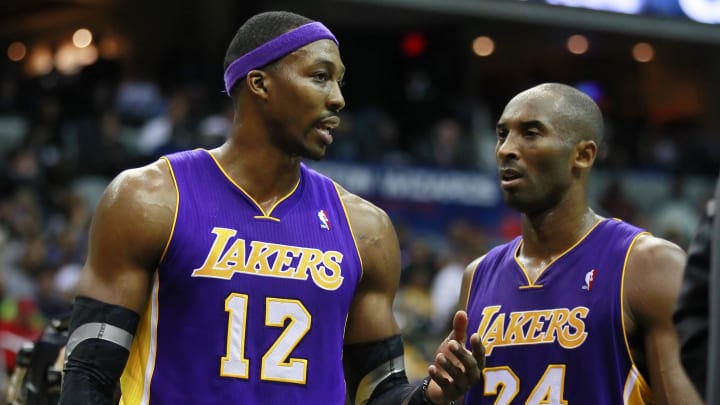 December 14, 2012; Washington, DC, USA;  Los Angeles Lakers shooting guard Kobe Bryant (24) and Lakers center Dwight Howard (12) talk on the court against the Washington Wizards in the fourth quarter at Verizon Center. The Lakers won 102-96. Mandatory Credit: Geoff Burke-USA TODAY Sports