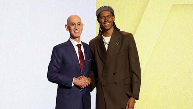 June 26, 2024; Brooklyn, NY, United States; Cody Williams poses for photos with NBA Commissioner Adam Silver after being selected in the