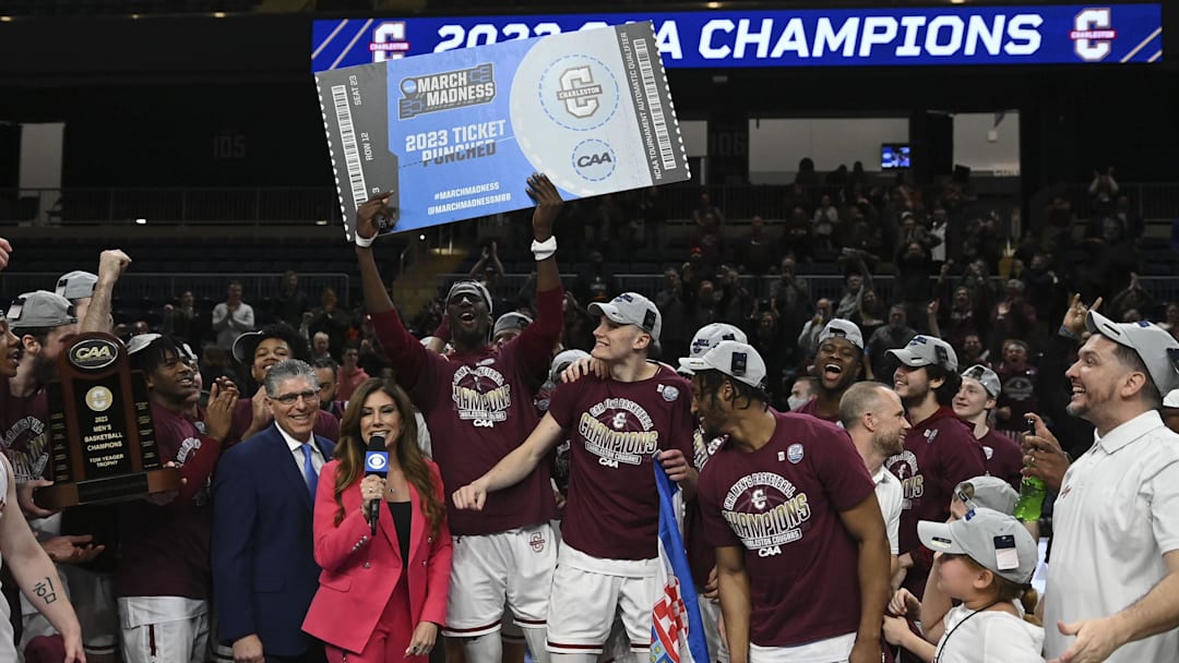 Mar 7, 2023; Washington, D.C., USA;  Charleston Cougars hoist their ticket to the 2023 March Madness tournament after defeating North Carolina-Wilmington Seahawks in the Colonial Athletic Association championship at Entertainment & Sports Arena. Mandatory Credit: Tommy Gilligan-Imagn Images