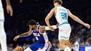 Nov 10, 2024; Philadelphia, Pennsylvania, USA; Philadelphia 76ers forward Paul George (8) controls the ball while slipping in front of Charlotte Hornets forward Tidjane Salaun (31) during the third quarter at Wells Fargo Center. Mandatory Credit: Bill Streicher-Imagn Images