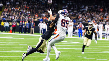 Aug 23, 2025; New Orleans, Louisiana, USA; Denver Broncos tight end Lucas Krull (85) catches a touchdown against New Orleans Saints safety Jordan Howden (31) during the first half at Caesars Superdome. Mandatory Credit: Stephen Lew-Imagn Images