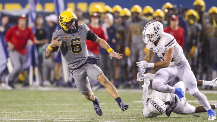 Sep 9, 2023; Morgantown, West Virginia, USA; West Virginia Mountaineers quarterback Garrett Greene (6) runs the ball during the second quarter against the Duquesne Dukes at Mountaineer Field at Milan Puskar Stadium. 