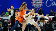 Indiana Fever guard Caitlin Clark (22) moves the ball against Connecticut Sun guard DiJonai Carrington (21) in the first quarter at Mohegan Sun Arena.