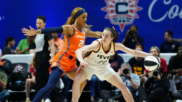 Indiana Fever guard Caitlin Clark (22) moves the ball against Connecticut Sun guard DiJonai Carrington (21) in the first quarter at Mohegan Sun Arena.