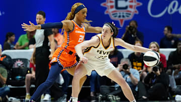 Jun 10, 2024; Uncasville, Connecticut, USA; Indiana Fever guard Caitlin Clark (22) moves the ball against Connecticut Sun guard DiJonai Carrington (21) in the first quarter at Mohegan Sun Arena. Mandatory Credit: David Butler II-Imagn Images