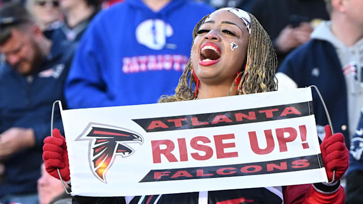 An Atlanta Falcons fan holds a sign 