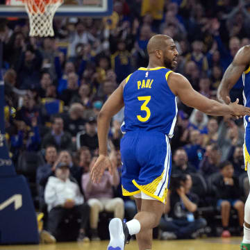 Mar 9, 2024; San Francisco, California, USA; Golden State Warriors forward Draymond Green (23) celebrates his three-point basket with teammate Chris Paul (3) during the first quarter against the San Antonio Spurs at Chase Center. Mandatory Credit: D. Ross Cameron-USA TODAY Sports