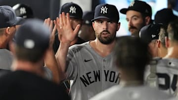 Apr 18, 2025; Tampa, Florida, USA; New York Yankees starting pitcher Carlos Rodon (55) is congratulated in the dugout after getting out of the sixth inning against the Tampa Bay Rays at George M. Steinbrenner Field.