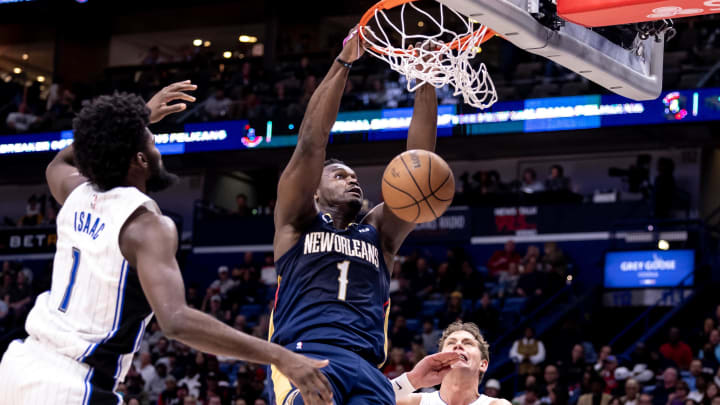 Apr 3, 2024; New Orleans, Louisiana, USA;  New Orleans Pelicans forward Zion Williamson (1) dunks the ball against Orlando Magic forward Jonathan Isaac (1) during the second half at Smoothie King Center.