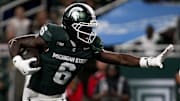 Nov 29, 2025; Detroit, Michigan, USA; Michigan State wide receiver Nick Marsh (6) stiff arms Maryland defensive back Jalen Huskey (22) in the second quarter at Ford Field. Mandatory Credit: Brendan Mullin-Imagn Images