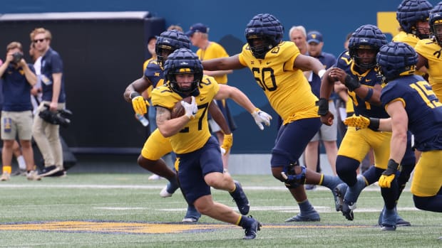 West Virginia University freshman running back Clay Ash bounces the run to the outside during the 2024 Gold-Blue Spring Game.
